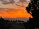 Beautiful sunset over the mountains with orange and yellow hues filling the sky at 11035 E Parker Rd, Parker, CO 80138