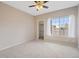 Spacious bedroom with a ceiling fan, closet, and large window at 1632 W Canal Cir # 924, Littleton, CO 80120