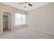 Bright bedroom with neutral carpet, a ceiling fan and closet space at 1632 W Canal Cir # 924, Littleton, CO 80120