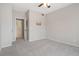 A neutral bedroom features a ceiling fan and an open door to the bathroom at 1632 W Canal Cir # 924, Littleton, CO 80120