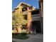Multi-story condo building features brick accents, well maintained landscaping and private balconies with white railings at 1632 W Canal Cir # 924, Littleton, CO 80120