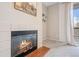 Close-up of a living room fireplace with sliding doors to balcony and light colored carpet at 1632 W Canal Cir # 924, Littleton, CO 80120