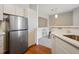 Well-equipped kitchen with stainless steel fridge and connection to dining area at 1632 W Canal Cir # 924, Littleton, CO 80120