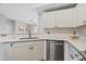 Bright kitchen featuring stainless steel appliances, laminate wood flooring and white cabinets at 1632 W Canal Cir # 924, Littleton, CO 80120