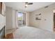 Sunlit living room with ceiling fan, sliding doors to balcony, and modern decor at 1632 W Canal Cir # 924, Littleton, CO 80120