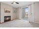 Bright living room with fireplace, ceiling fan, and sliding glass doors leading to a balcony at 1632 W Canal Cir # 924, Littleton, CO 80120