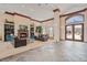 Bright lobby area with fireplace, shelving, stone floors, and large windows looking out to a community pool at 1632 W Canal Cir # 924, Littleton, CO 80120
