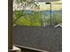 View of roof shingles overlooking lush green trees, mountains and sky in the distance from an elevated height at 1632 W Canal Cir # 924, Littleton, CO 80120