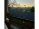 Sunset view of tree-lined mountains from condo balcony overlooking a walkway and surrounding neighborhood at 1632 W Canal Cir # 924, Littleton, CO 80120