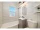 Bright bathroom with modern vanity, tub, and tiled walls at 2570 Jay St, Edgewater, CO 80214