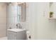 Updated bathroom with a modern vanity, tiled walls, and a sleek showerhead at 2570 Jay St, Edgewater, CO 80214