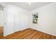 Bedroom with hardwood floors, large window, closet and neutral paint at 2570 Jay St, Edgewater, CO 80214