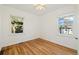 Light-filled bedroom featuring hardwood floors and two windows at 2570 Jay St, Edgewater, CO 80214