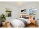 Bright bedroom with two windows, hardwood floors, and a ceiling fan at 2570 Jay St, Edgewater, CO 80214