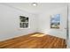 Bedroom features hardwood floors, natural light from two windows, and fresh white paint at 2570 Jay St, Edgewater, CO 80214