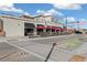 Exterior view showcasing an outdoor patio area of a commercial space with red umbrellas at 2570 Jay St, Edgewater, CO 80214