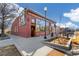 Exterior view of a commercial building, showcasing architectural details and outdoor seating at 2570 Jay St, Edgewater, CO 80214