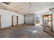 Spacious garage with shelves and storage, featuring a roll-up door and ample natural light at 2570 Jay St, Edgewater, CO 80214