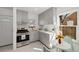 Bright kitchen with stainless steel appliances, white countertops, and gray cabinets at 2570 Jay St, Edgewater, CO 80214