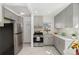 Updated kitchen with stainless steel appliances and gray cabinets at 2570 Jay St, Edgewater, CO 80214