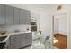 Modern kitchen featuring sleek gray cabinetry, white countertops, and stainless steel appliances at 2570 Jay St, Edgewater, CO 80214