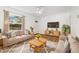 Bright living room with hardwood floors, comfortable seating, and large windows offering natural light at 2570 Jay St, Edgewater, CO 80214
