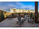 A charming patio featuring Adirondack chairs and an iron dining set, perfect for relaxing outdoors at 5506 Water Avens Dr, Castle Rock, CO 80104