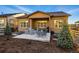 Relaxing backyard featuring a covered patio with comfortable seating, a grill, and beautiful landscaping at 5506 Water Avens Dr, Castle Rock, CO 80104
