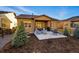 Inviting backyard featuring a patio with comfortable seating, a grill, and lush landscaping at 5506 Water Avens Dr, Castle Rock, CO 80104