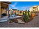 An inviting patio with modern outdoor seating, a grill, and manicured landscaping with young trees at 5506 Water Avens Dr, Castle Rock, CO 80104