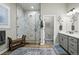 Modern bathroom featuring a glass-enclosed shower, dual sinks, and stylish fixtures at 5506 Water Avens Dr, Castle Rock, CO 80104