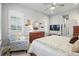 Inviting bedroom with ceiling fan, plush bedding, and shuttered windows allowing for plenty of natural light at 5506 Water Avens Dr, Castle Rock, CO 80104