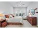 Inviting bedroom with ceiling fan, plush bedding, and shuttered windows allowing for plenty of natural light at 5506 Water Avens Dr, Castle Rock, CO 80104