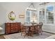 Charming dining room featuring a wooden table set and a vintage hutch with ample natural light at 5506 Water Avens Dr, Castle Rock, CO 80104