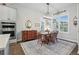 Charming dining room featuring a wooden table set and a vintage hutch with ample natural light at 5506 Water Avens Dr, Castle Rock, CO 80104