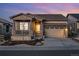 Charming single-Gathering home features a covered porch, attached two-car garage, and low maintenance landscaping at 5506 Water Avens Dr, Castle Rock, CO 80104