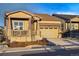 Inviting home boasts a covered porch, a well-kept lawn, and an attached two-car garage at 5506 Water Avens Dr, Castle Rock, CO 80104
