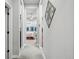 Inviting hallway leads to a bright bedroom with large windows and ample natural light at 5506 Water Avens Dr, Castle Rock, CO 80104