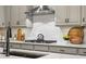 Detailed shot of the kitchen, highlighting the countertops, gas stove, and stylish backsplash at 5506 Water Avens Dr, Castle Rock, CO 80104