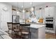 Spacious kitchen with island seating, stainless steel appliances, and modern pendant lighting at 5506 Water Avens Dr, Castle Rock, CO 80104