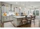 Modern kitchen featuring a large island, stainless steel appliances, and a view of the dining area at 5506 Water Avens Dr, Castle Rock, CO 80104