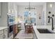 Bright eat-in kitchen boasts stainless appliances, white cabinets, and a cozy dining area with natural light at 5506 Water Avens Dr, Castle Rock, CO 80104