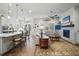 Open concept living room features a fireplace, ceiling fan, large island and lots of natural light at 5506 Water Avens Dr, Castle Rock, CO 80104
