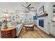 Bright living room features a stone fireplace, a ceiling fan, and lots of natural light at 5506 Water Avens Dr, Castle Rock, CO 80104