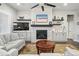 Inviting living room with stone fireplace, modern ceiling fan, and stylish decor on floating shelves at 5506 Water Avens Dr, Castle Rock, CO 80104