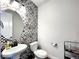 Powder room with patterned tile, pedestal sink, and a modern toilet at 4525 Cholla Trl, Castle Rock, CO 80104