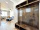 Entryway with built-in bench, coat hooks, and wood-paneled walls at 4525 Cholla Trl, Castle Rock, CO 80104