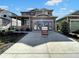 Two-story Craftsman home with gray siding, light-colored stone accents, and a three-car garage at 4525 Cholla Trl, Castle Rock, CO 80104
