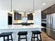 Modern kitchen with dark cabinetry, white quartz countertops, and stainless steel appliances at 4525 Cholla Trl, Castle Rock, CO 80104
