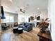 Open-concept living room with hardwood floors, a cozy sitting area, and a view of the kitchen at 4525 Cholla Trl, Castle Rock, CO 80104